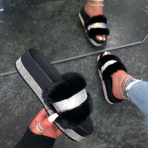 Fuzzy house slippers with diamonds.